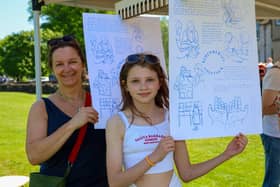 Nicky Monaghan and her daughter Ella, 10, at the drying rack with their prints of Caspar's work.