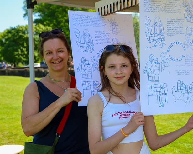 Nicky Monaghan and her daughter Ella, 10, at the drying rack with their prints of Caspar's work.