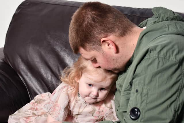Arya with dad Jordan at home in Grangemouth after she was diagnosed with a rare brain tumor 
(Picture: Michael Gillen, National World)