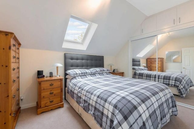 The main bedroom has a Velux window and built-in mirrored wardrobe with additional overhead storage.