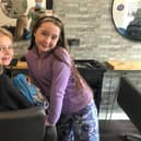 Lily and Grace pictured at the hairdressers before the charity chop.