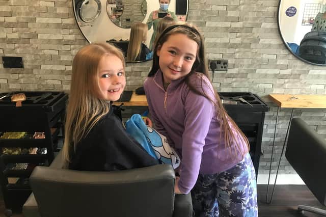 Lily and Grace pictured at the hairdressers before the charity chop.