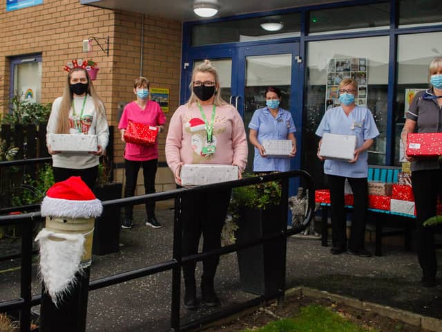 Dunelm Falkirk deputy manager Jemma Hain (centre) and her colleague Chelsea Polson (Front left) deliver shoe boxes of gifts donated by the local community, for the residents of Wallace View Care Home in Stirling.