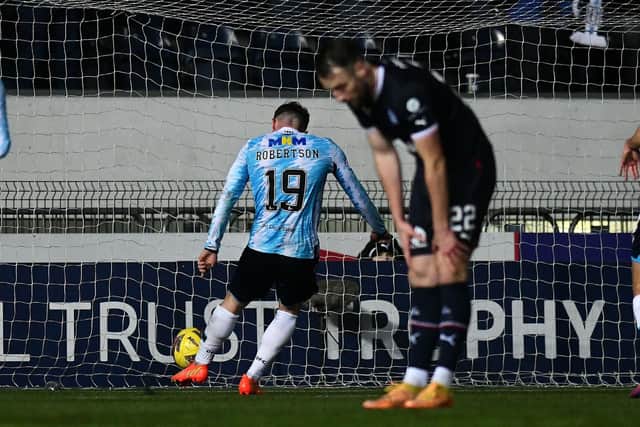 Finlay Robertson rounded off the scoring for Dundee; a dejected Brad McKay (blurred) after the goal