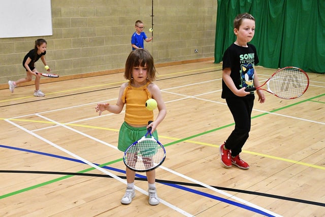 Concentration as this youngsters gets in some racquet practice.
