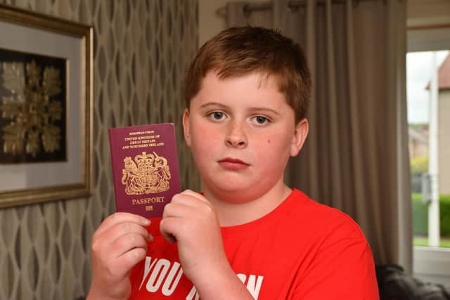 Ryley McGuckin, 11, with his passport Ryanair staff claimed wasn't valid for his holiday flight
