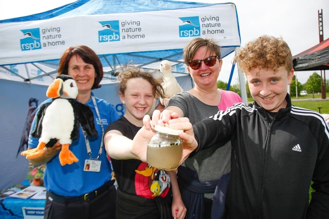 RSPB Membership fundraiser Mhairi Campbel teaches Gail Leckie and her children Ryan, 12, and Murron, 10, from Falkirk about plastic nurdles - the plastic particles that cause water pollution.