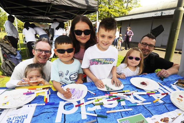 Erin (2) and dad Chris Thompson making butterfly plates at the event, alongside  Thomas (5), Philip (7), and Helen (4) with parents Anna and Peter Kuzlak.