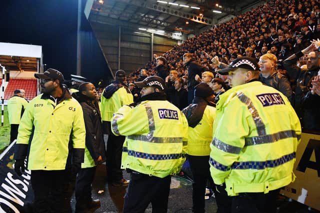27-12-2024. Picture Michael Gillen. DUNFERMLINE. East End Park. Dunfermline Athletic FC v Falkirk FC. Season 2024 - 2025. SPFL William Hill Championship. Match Day 19. Falkirk fans being watched by Police Scotland and security staff.
