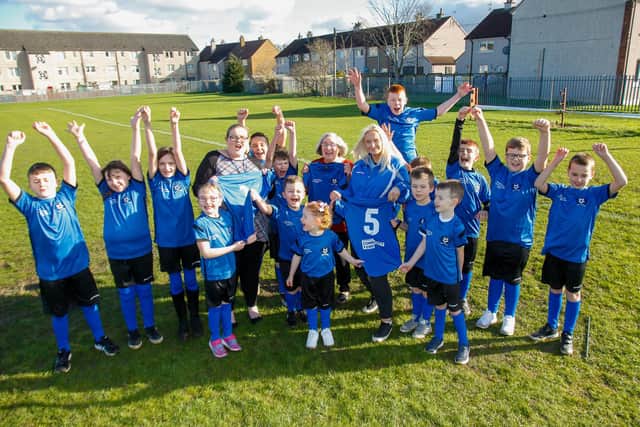 Mini Bairns football team with Big Bairns football team with Adele, Betty and Chloe at Westfield Park Community Centre 19/02/20 with their new strips donated by Arnold Clark