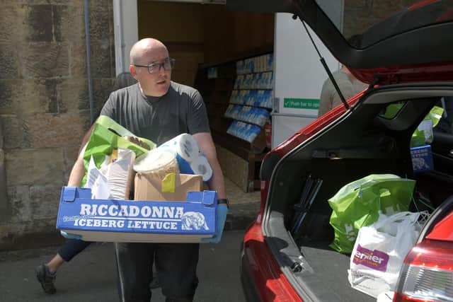 Keeping Larbert and Stenhousemuir Beautiful Community Pantry (KLSB Community Pantry) volunteers and Stenhousemuir FC Community Help Initiative loading cars and distributing food parcels to those in need and self-isolating.