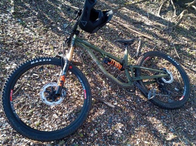 The stolen bike is a green Saracen Aries 60 Elite mountain bike with distinctive gold coloured suspension.