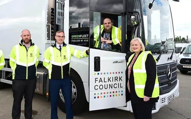 One of the green fuelled bin lorries. Pictured: Falkirk Council Leader, Councillor Cecil Meiklejohn and Councillor Bryan Deakin, spokesperson for climate change (in cab), with members of the Council's environment & operations management team. Pic: Falkirk Council