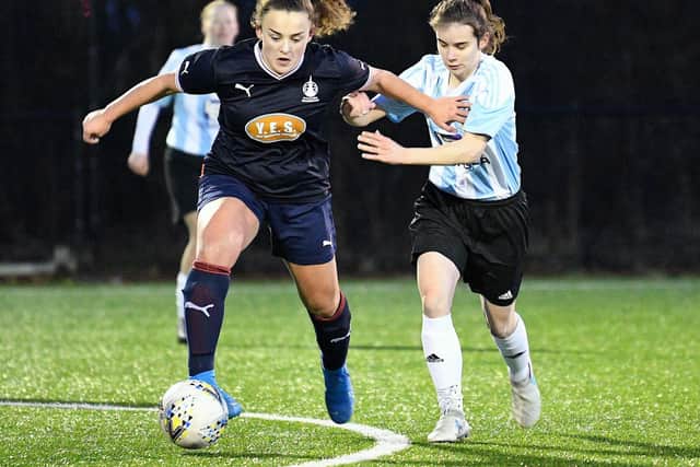 Falkirk's Iona Bridges looks to drive forward in possession of the ball against Westdyke