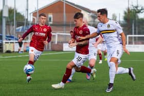 Stenhousemuir's Matty Yates drives forward under heavy pressure from Dumbarton's Stuart Carswell (Pics by Scott Louden)