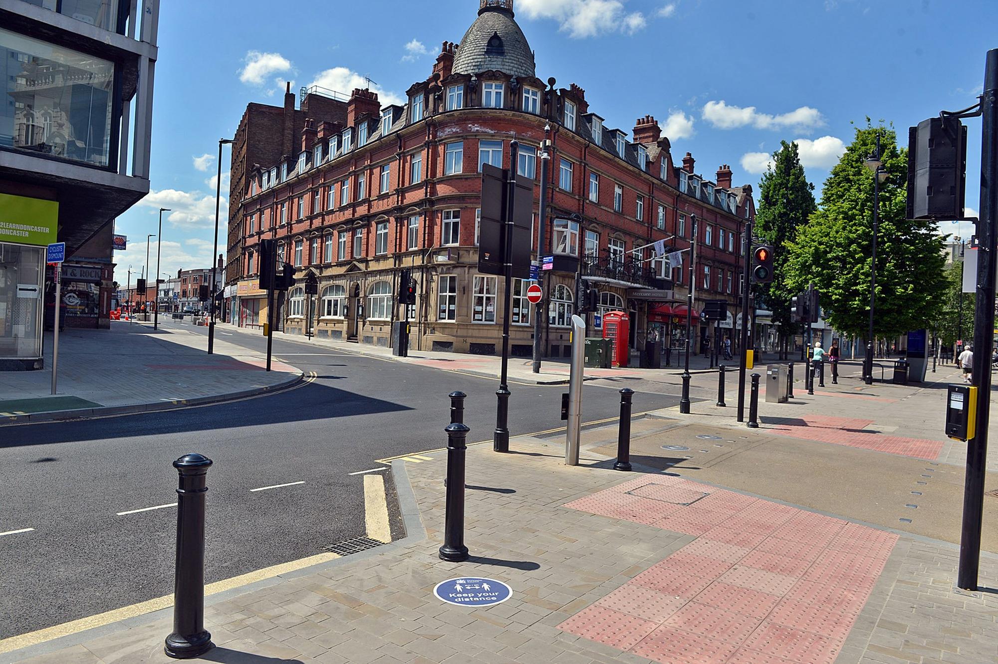 Doncaster town centre is being marked out with for social distancing signs.  Note the Keep Your Distance sign