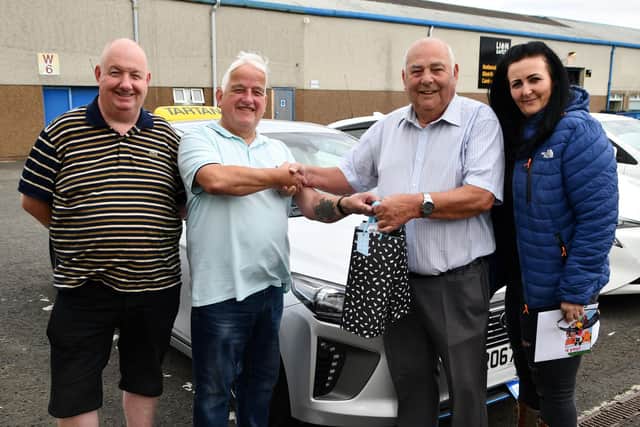 Tartan Taxis' directors Michael Sloan, Allan Dickie and Louise McMeechan present Tom Stirling with his retirement gifts
