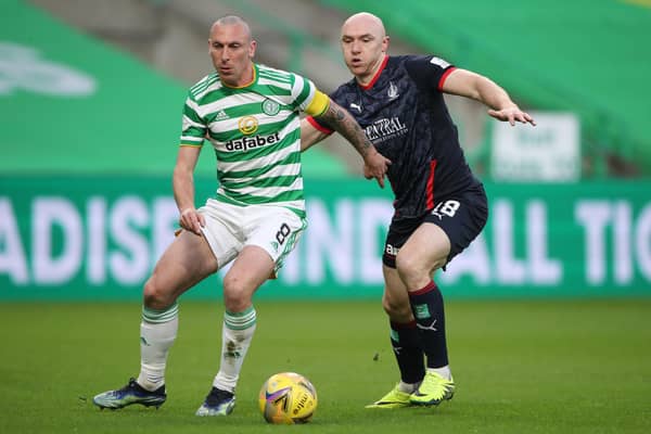 Celtic's Scott Brown being challenged by Falkirk's Conor Sammon during their sides' Scottish Cup third-round match today in Glasgow (Photo by Ian MacNicol/Getty Images)