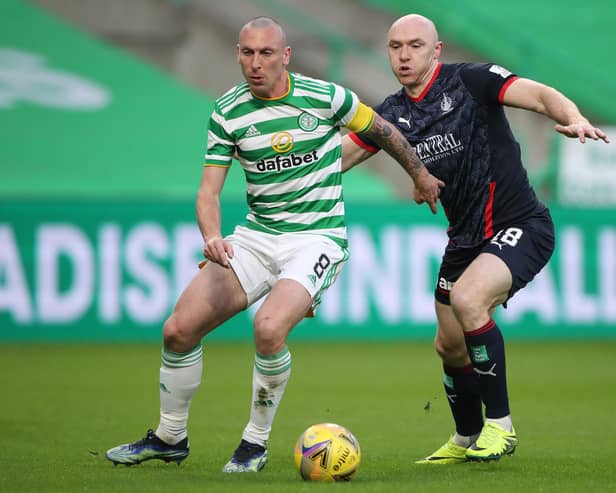 Celtic's Scott Brown being challenged by Falkirk's Conor Sammon during their sides' Scottish Cup third-round match today in Glasgow (Photo by Ian MacNicol/Getty Images)