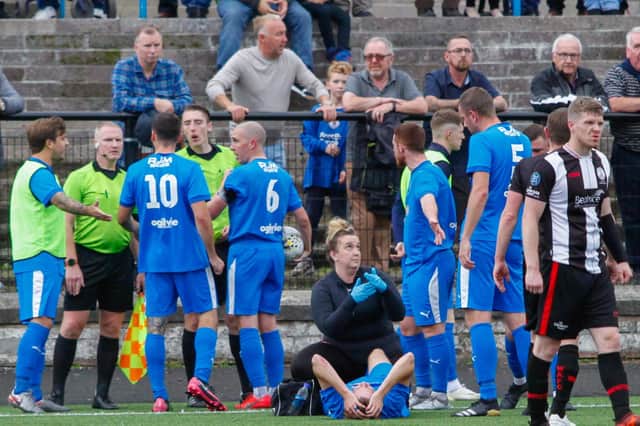 Zander Miller lies in agony on the pitch after sustaining an ankle break during Saturday's clash against Wick (Pic by Scott Louden)