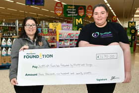 Morrisons Falkirk community champion Charlotte Counsell presents a cheque to Clare Morrison of Scottish Families Affected by Alcohol and Drugs.