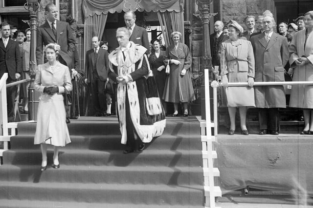 The Queen and Duke of Edinburgh leaving the Burgh Buildings in Falkirk accompanied by Provost R H Watson.  Behind the Provost is James Stuart, Secretary of State for Scotland.  The visit was part of a state visit to West Lothian.