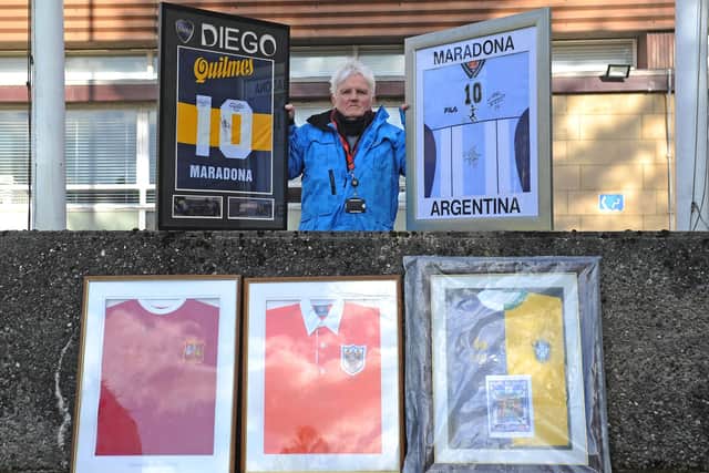 Provost Billy Buchanan with some of the football shirts he is going to auction to raise money for Bonnybridge and Larbert projects. Among his collection are signed Diego Maradona, George Best and Stanley Matthews jerseys, as well as a France v Brazil 1998 World Cup final commemorative top. Picture: Michael Gillen.