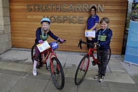 Strathcarron Hospice ward sister Susan Bateman thanks Falkirk Junior Bike Club members Carly Scott, 7, and Freya McQueen, 8, for the group's fundraising efforts on behalf of the Fankerton service. Picture: Michael Gillen.
