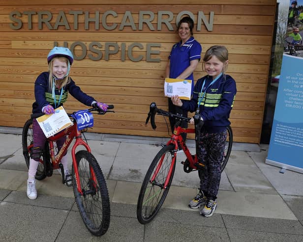 Strathcarron Hospice ward sister Susan Bateman thanks Falkirk Junior Bike Club members Carly Scott, 7, and Freya McQueen, 8, for the group's fundraising efforts on behalf of the Fankerton service. Picture: Michael Gillen.