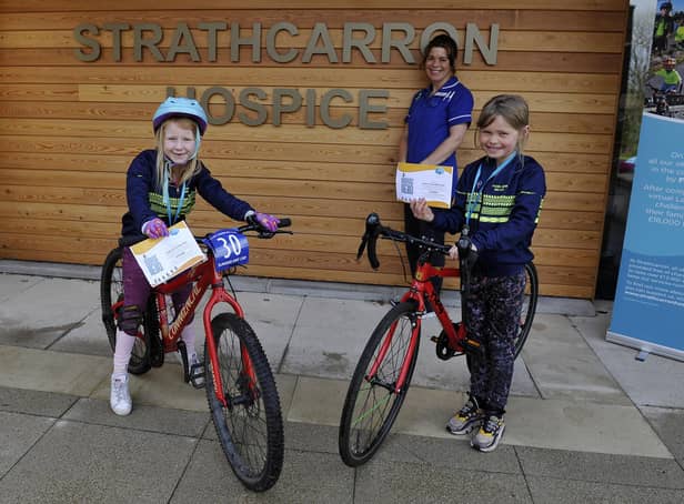 Strathcarron Hospice ward sister Susan Bateman thanks Falkirk Junior Bike Club members Carly Scott, 7, and Freya McQueen, 8, for the group's fundraising efforts on behalf of the Fankerton service. Picture: Michael Gillen.