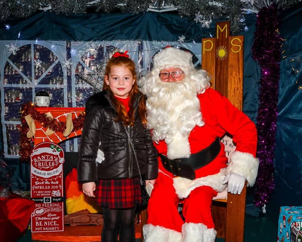 Seven-year-old Sapphire meets Santa at Sunday's Christmas Fayre.