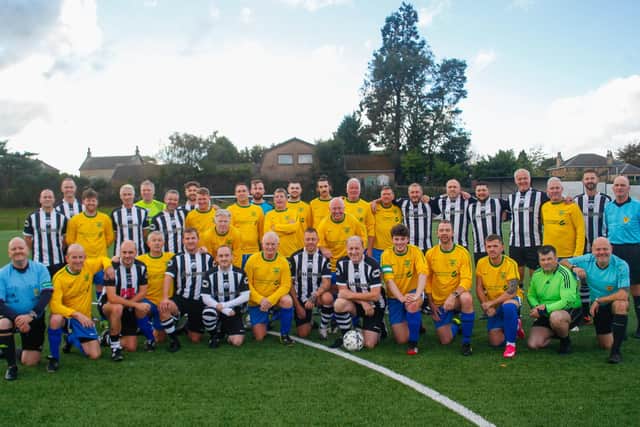 The teams line-up before the match.  Santa's Superstars wearing yellow and Cammy's Legends in the black and white stripes of Dunipace. Pic: Scott Louden.