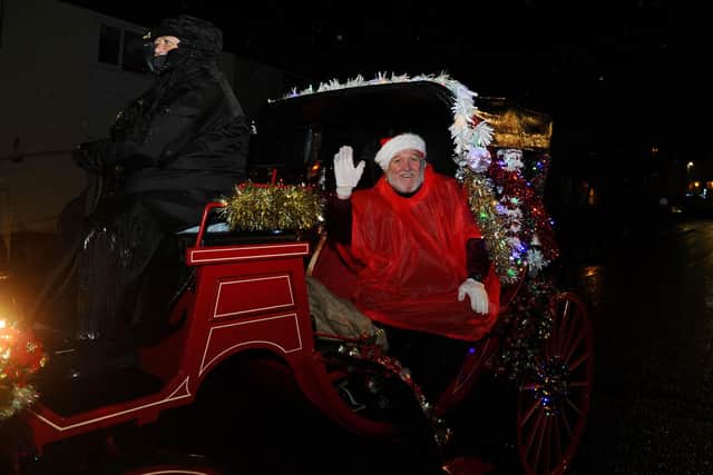 Santa and elves handed out gifts during Camelon Winter Festival. Picture: Michael Gillen.