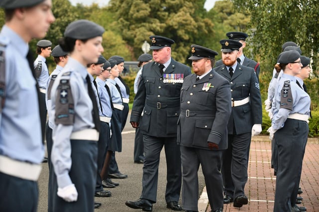 Squadron officers follow Squadron Leader Robert Sandison during the inspection.