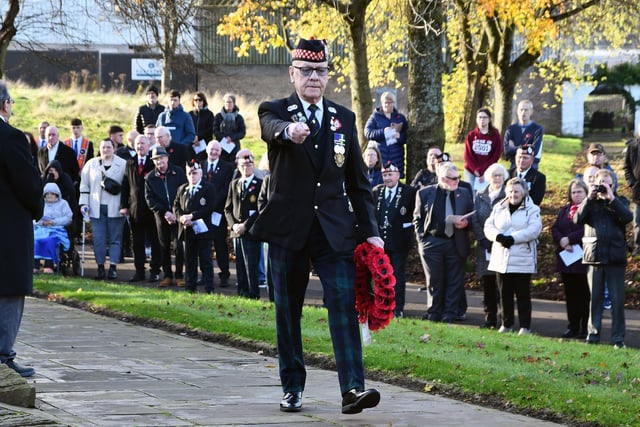 A veteran marches smartly to lay his wreath at Camelon