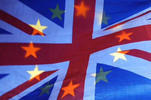 File photo of an EU and Union flag held aloft in Westminster, London.