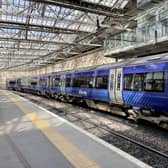 A ScotRail train waiting at the platform at Edinburgh's Waverley Station. ScotRail's new timetable, which will see almost 700 fewer train services a day across Scotland, begins today whilst the deadlock over driver pay continues. Picture date: Monday May 23, 2022.