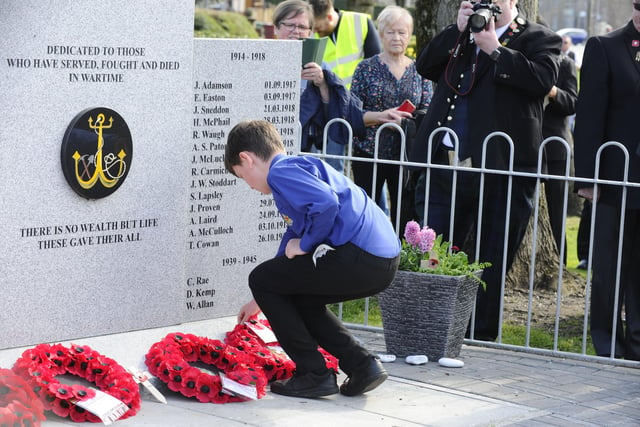 A wreath is laid by a member of The Boys' Brigade who took part in the parade and service