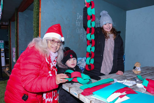 Theo, 5, and Alesha, 10, make festive garlands