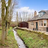 Not many properties these days can boast their own brook running gently in the front of the house.