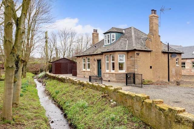 Not many properties these days can boast their own brook running gently in the front of the house.