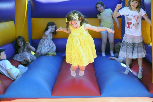 Ava-Jayne Rhind in her yellow dress on the bouncy castle.