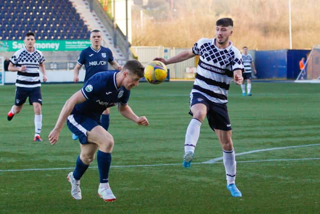 Dean Watson looks to steal possession