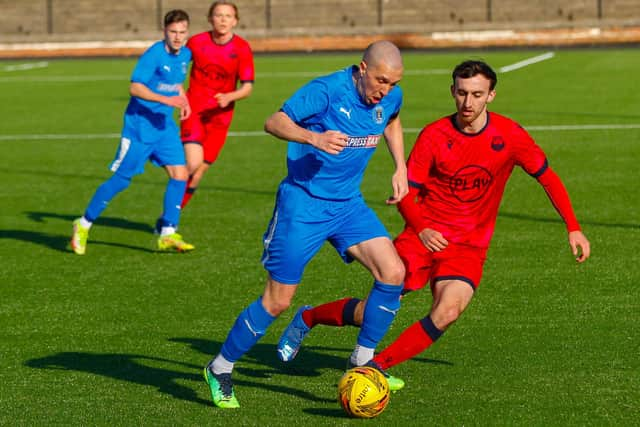 Michael Gemmell drives forward with the ball