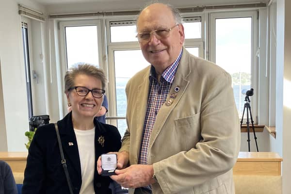 RNLI chairwoman Janet Legrand was delighted to present Tom Robertson with his 50 years’ service medal.