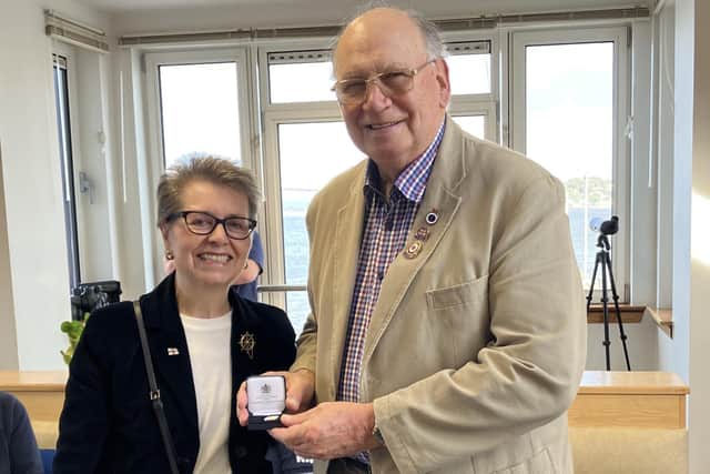 RNLI chairwoman Janet Legrand was delighted to present Tom Robertson with his 50 years’ service medal.