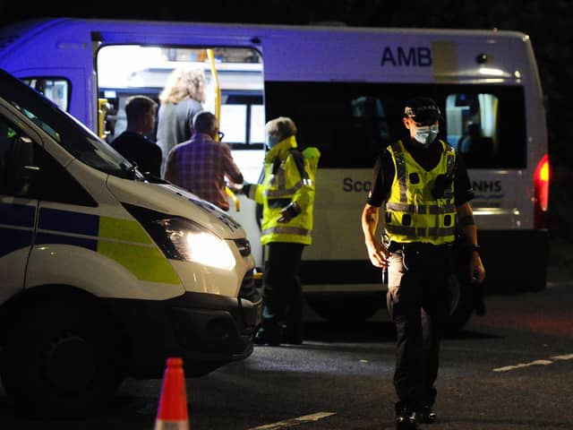 Hotel residents unable to get back to the hotel take to shelter in an ambulance following the evacuation