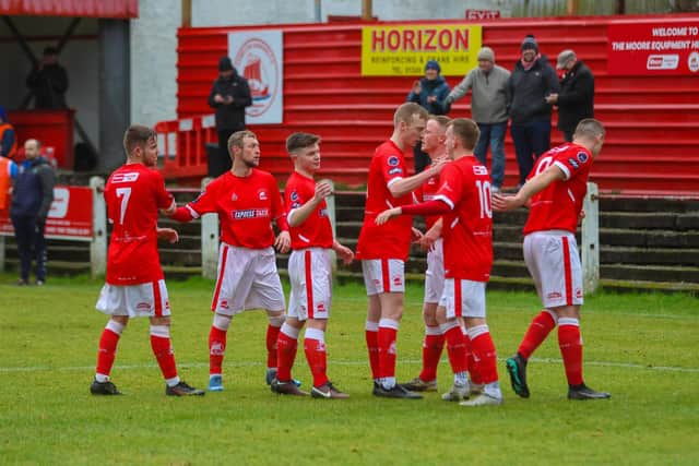 Callum Robertson is mobbed by his team-mates after putting Camelon 1-0 up from the spot (Pics by Scott Louden)