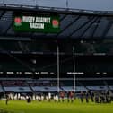 Some players stand and others take the knee in support of the Black Lives Matter movement ahead of the Six Nations rugby union match between England and Scotland at Twickenham Stadium in south west London on February 6, 2021. (Photo by Adrian DENNIS / AFP) (Photo by ADRIAN DENNIS/AFP via Getty Images)