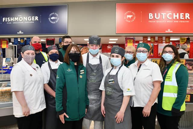 Morrisons upgraded Falkirk store -  Nairn Diver, store manager (back left red facemask) with colleagues at the new fishmonger and butcher counters.